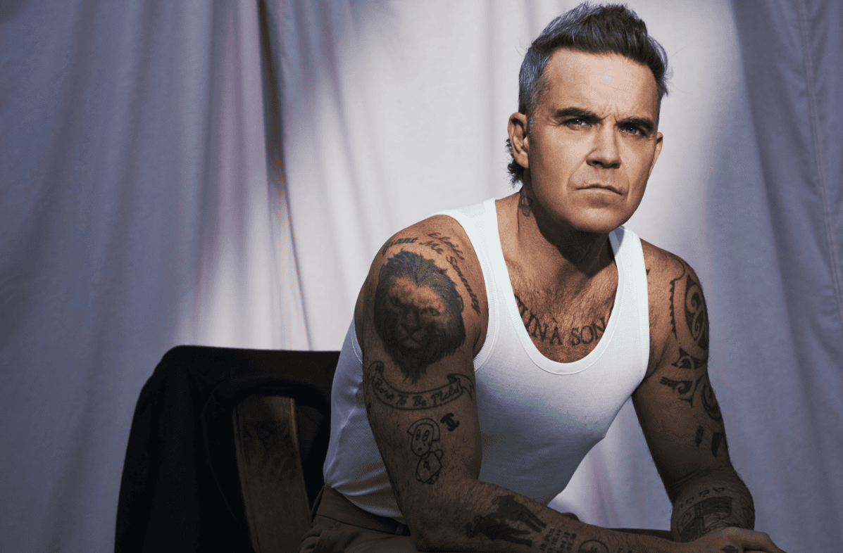 Robbie Williams Still Reigns as a Pop Icon and Here’s Why the World Can’t Get Enough